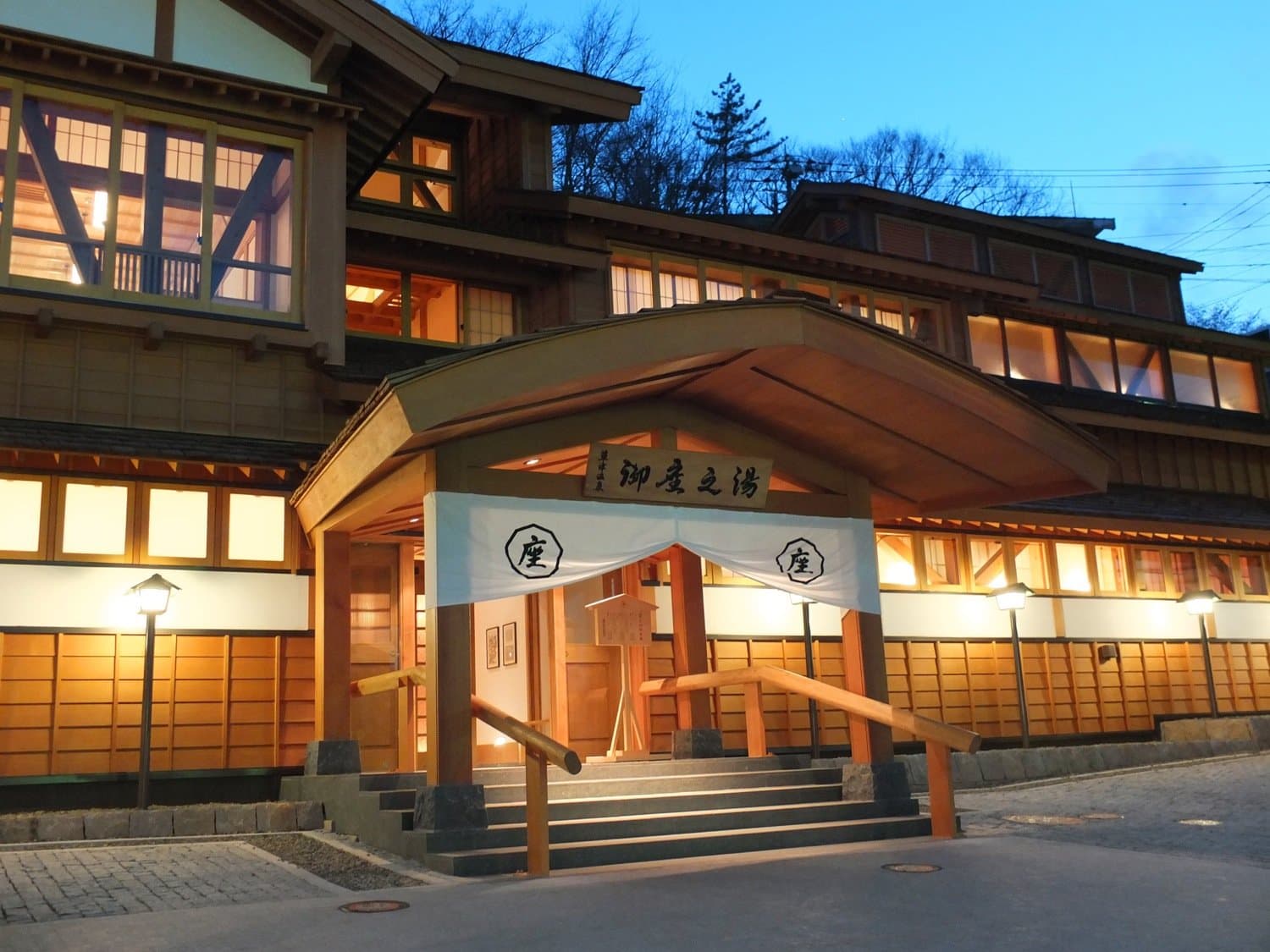 The Gozanoyu public bathhouse beside the Yubatake in Kusatsu at dusk